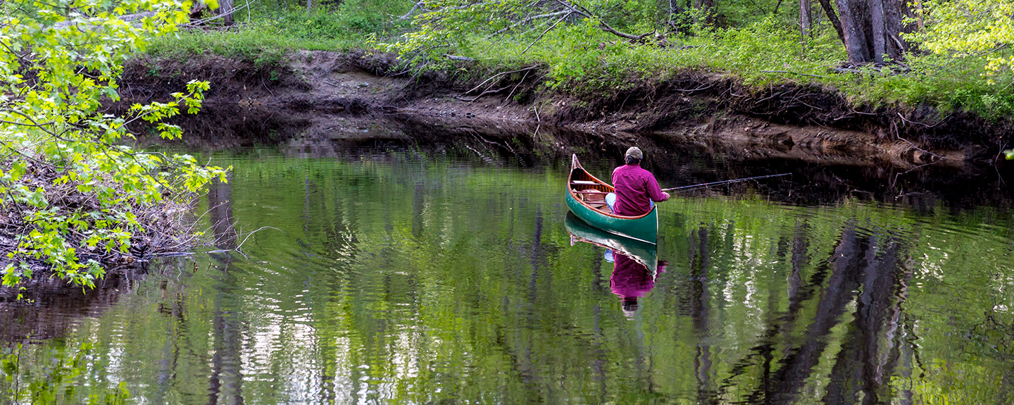 man canoeing on the Lamprey River, photo by Jerry Monkman